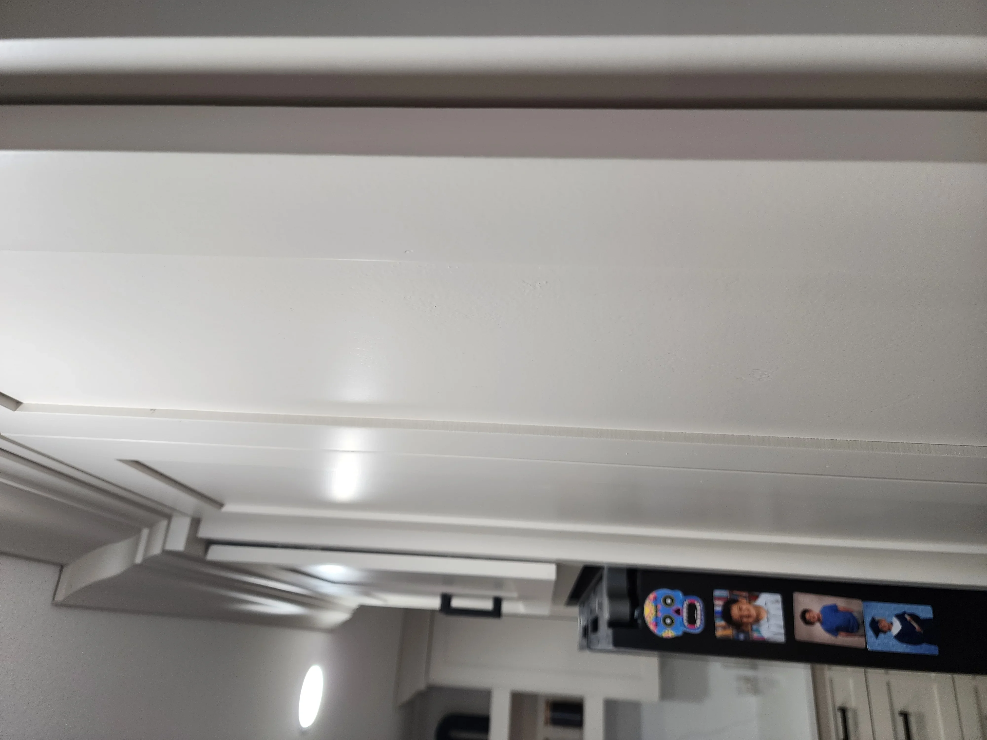 Finished drywall ceiling and walls with recessed lighting and smooth joint compound finish